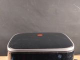 a black and silver device sitting on top of a wooden table