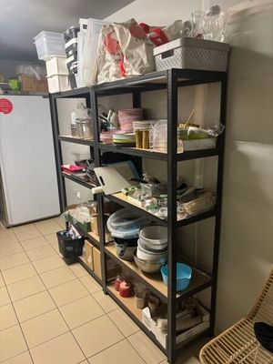 a shelf with dishes and bowls on it in a kitchen