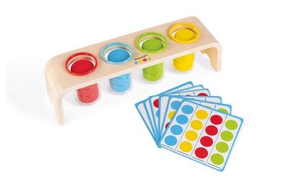a close up of a wooden tray with cups and cards on it