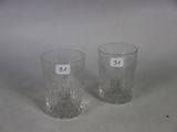two glasses sitting on a table with labels on them