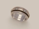 a close up of a ring with diamonds on it