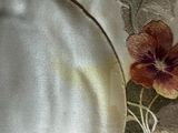 a close up of a white plate with a flower design on it