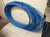 a close up of a bunch of blue wires on a floor