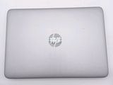 a laptop with a sticker on it sitting on a table