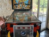 a pinball machine that is sitting in a room