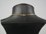 a black mannequin with a gold chain on it