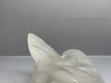 a white bird that is sitting on top of a table