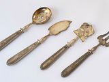 four pieces of silverware including a fork, spoon, and knife