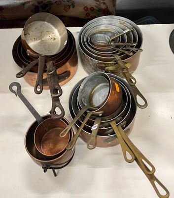 de nombreuses casseroles et poêles posées sur une table