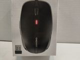 a black mouse in a clear box on a white table