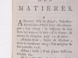 an old book with writing on it sitting on a table