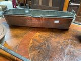 a large metal pan sitting on a wooden table