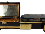 a black and gold vanity with a mirror on it