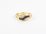 a close up of a gold ring with a sapphire and diamond
