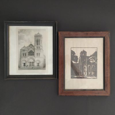 two framed pictures hanging on the wall of a room