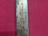a close up of a knife on a red cloth on a table