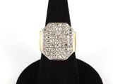 a close up of a diamond ring on a black ring stand