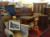 a room filled with antique furniture and antiques on display