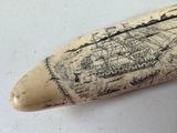 a whale tooth with a drawing of a ship on it
