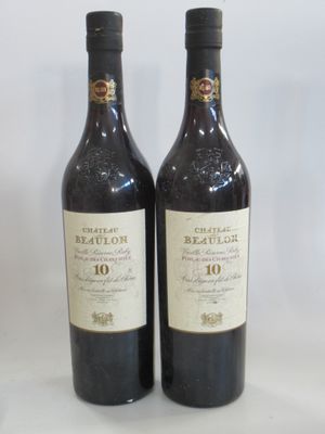 two bottles of red wine sitting next to each other on a table