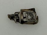 a silver ring with a diamond in it on a white surface
