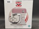 packaging of a pink kenwood mixer sitting on top of a table