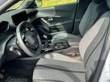 the interior of a car with the door open and the driver ' s seat down