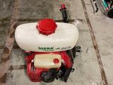 a red and white sprayer sitting on the floor