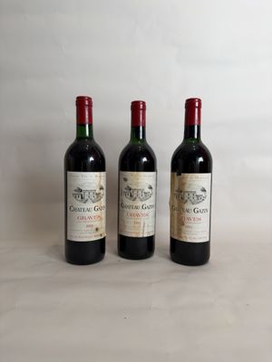 three bottles of wine sitting on top of a table next to each other