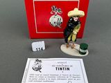 a small figurine of a man with a hat on a table