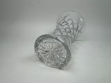 a broken glass vase sitting on a white surface