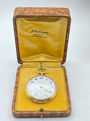 an antique pocket watch in a wooden case with a yellow lining