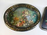 two trays that have flowers on them on a table