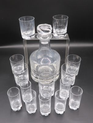 many glasses and a decanter sitting on a table