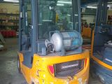 two yellow forklifts parked in a warehouse