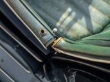 a close up of a seat in a car with a green seat cover