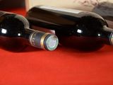 two bottles of wine sitting next to each other on a table