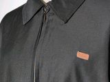 the back of a black jacket with a leather patch on it