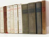 books are lined up in a row on a white surface
