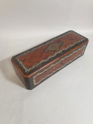 an old wooden box sitting on top of a white surface