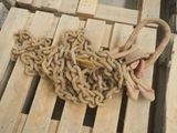 a large pile of chains on a pallet next to a pair of scissors