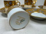 four cups and a saucer on the table