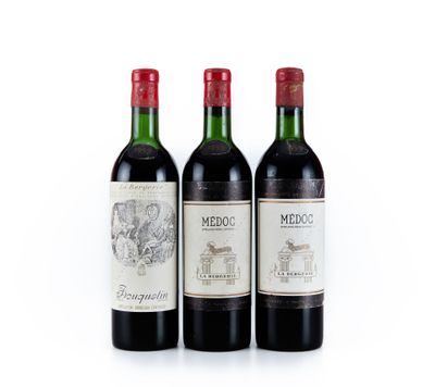trois bouteilles de vin sont alignées sur une surface blanche