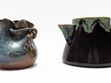 deux vases posés l'un à côté de l'autre sur une surface blanche