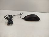 a black computer mouse sitting on a white surface