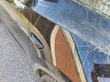 a black car with a mirror on the side of it