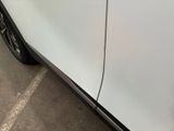 a close up of a white car with a black stripe on the side of it
