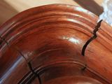 a close up of a piece of wood on a bed