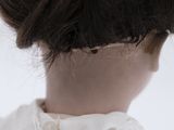 a close up of a woman ' s head with a white shirt on