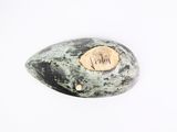 a stone with a carved heart on it on a white surface